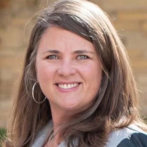 Headshot of Erin Gallagher Klau with shoulder length brown hair, green sparkling eyes, and warm smile.