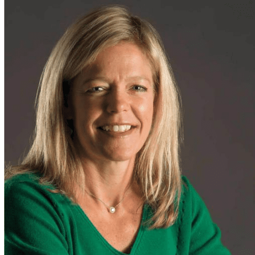 A headshot of Karen Keyes. Midlength blonde hair, wearing a signature Notre Dame green shirt.