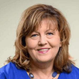 Headshot of Cathy David with shoulder-length brown hair, a friendly smile and nice blue shirt.