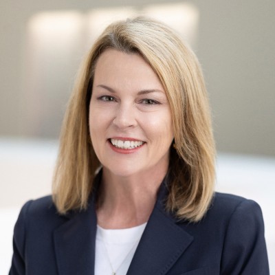 blonde woman wearing suit jacket smiling professionally